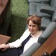Suzanna Sheed MP sitting in Parliament house looking at camera. Camera is positioned above her in the House.